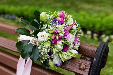 Beautiful bridal bouquet of flowers on wooden bench