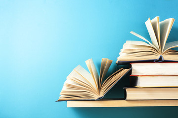 Open book, hardback books on wooden table. Education background. Back to school. Copy space for text.