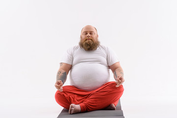 Man meditating on yoga mat