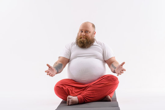 Man Sitting On A Yoga Mat