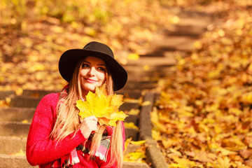 Fototapeta na wymiar Woman relaxing in autumn fall park