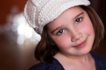 Portrait of a beautiful young girl in a woven hat