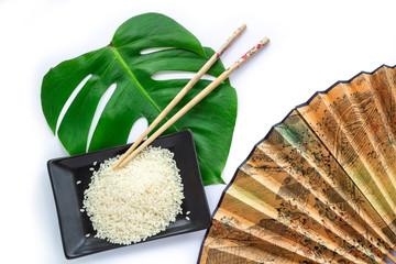 Oriental set of rice, chopsticks, green leaf and transp