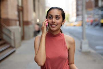 Young woman in city talking on cell pohne