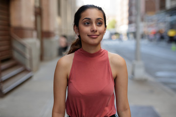 Young woman in city walking smile happy face