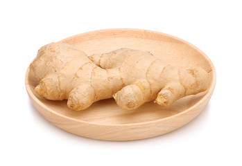 fresh ginger on wooden plate