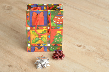 A colorful christmas gift bag with bows