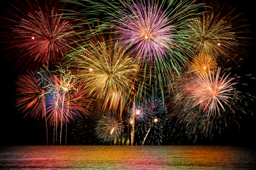 Colorful firework celebration on dark night sky background.