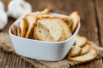 Bread chips on wooden background