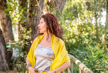 Fototapeta premium glamorous mature woman in a green park