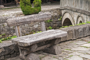Vintage wooden bench on stoned river bank alley