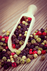 Vintage photo, Fresh colored pepper with spoon on wooden background