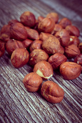 Vintage photo, Heap of brown hazelnut on wooden table