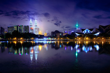Night view of kuala lumpur city with reflection in water