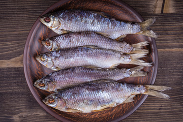 Dry fish on a wooden background