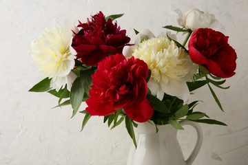 Peonies bouquet in white jug