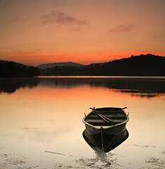 Fishing Boat on a Calm Lake at Sunrise