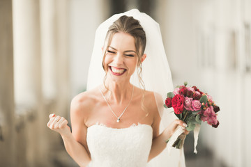 Luxury wedding bride, girl posing and smiling with bouquet