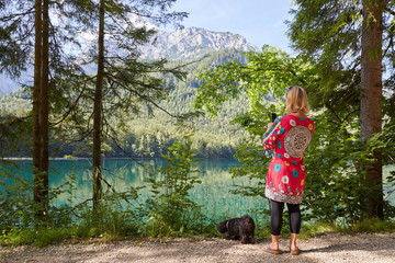 Woman taking a photo of lake Vorder Langbathsee