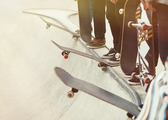 Skateboarding wallpaper. Group of skateboarders standing on a ramp top in a skatepark.  © hurricanehank
