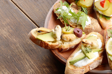 Open sandwiches with salmon, eggs, mussels, jamon and herring