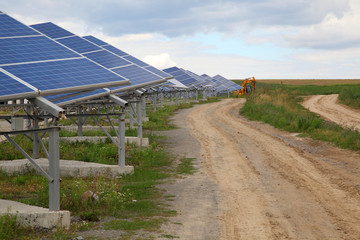 Solar panels near a rural road. Installation of solar panels in rural areas.