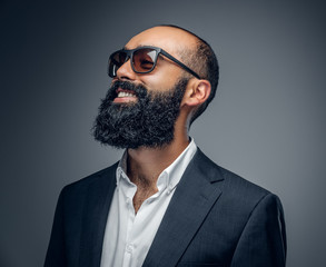 Portrait of bearded male in a suit and sunglasses.