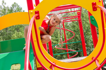 Portrait preschool caucasian girl playing on the playground