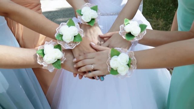 The bride with the bridesmaids joined hands 