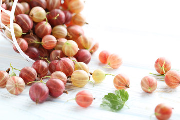 Gooseberries fruit on a white wooden table