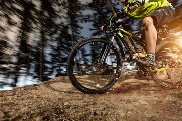 Naklejka premium Low angle view of mountain biker riding on trail
