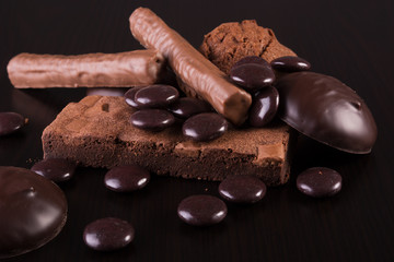 Variety of Chocolate sweets on dark wooden background