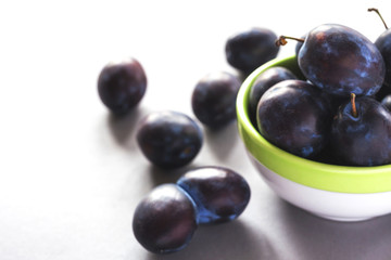 Sweet ripe plums on rustic background. Close-up.