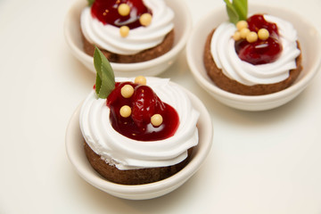  mini cakes with cherry filling and cream in white cup