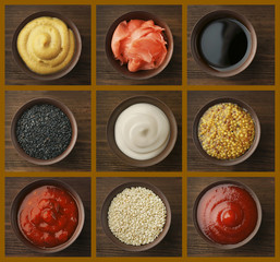 Set of different sauces on wooden background.