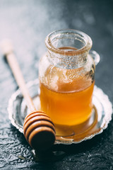 Honey in a pot or jar on kitchen table