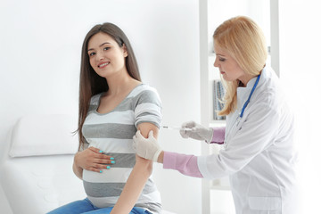 Doctor making injection a pregnant woman at the hospital