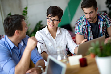Happy young business people talking