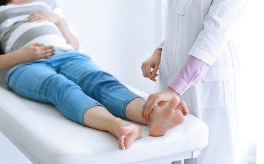 Young pregnant woman with doctor at the hospital