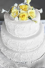 Beautiful wedding cake decorated with yellow roses