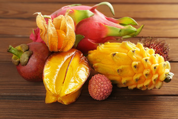 Tasty exotic fruits on wooden background