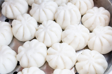 Steamed stuff bun or salapao on green background. Chinese food c