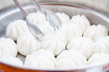 Steamed stuff bun or salapao on green background. Chinese food c