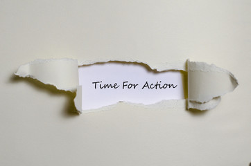 The word time for action appearing behind torn paper