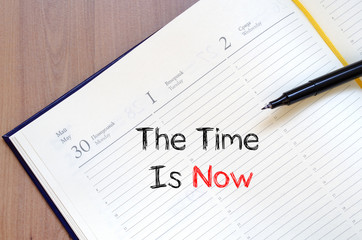 The time is now text concept on notebook