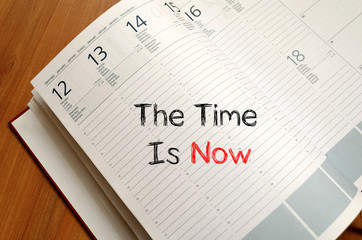 The time is now text concept on notebook