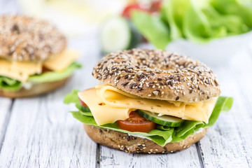 Wooden table with Cheese Bagel (selective focus)