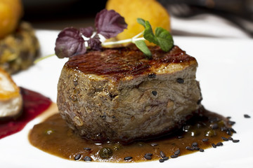 Grilled beef steak served with kaper sauce