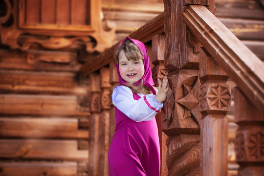 Masha on the porch of a wooden house