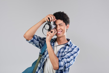 Young photographer man taking photo with vintage camera